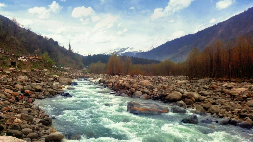 pexels-photo-795155-795155 Beautiful mountain river flowing through a rocky valley with distant snowy peaks.